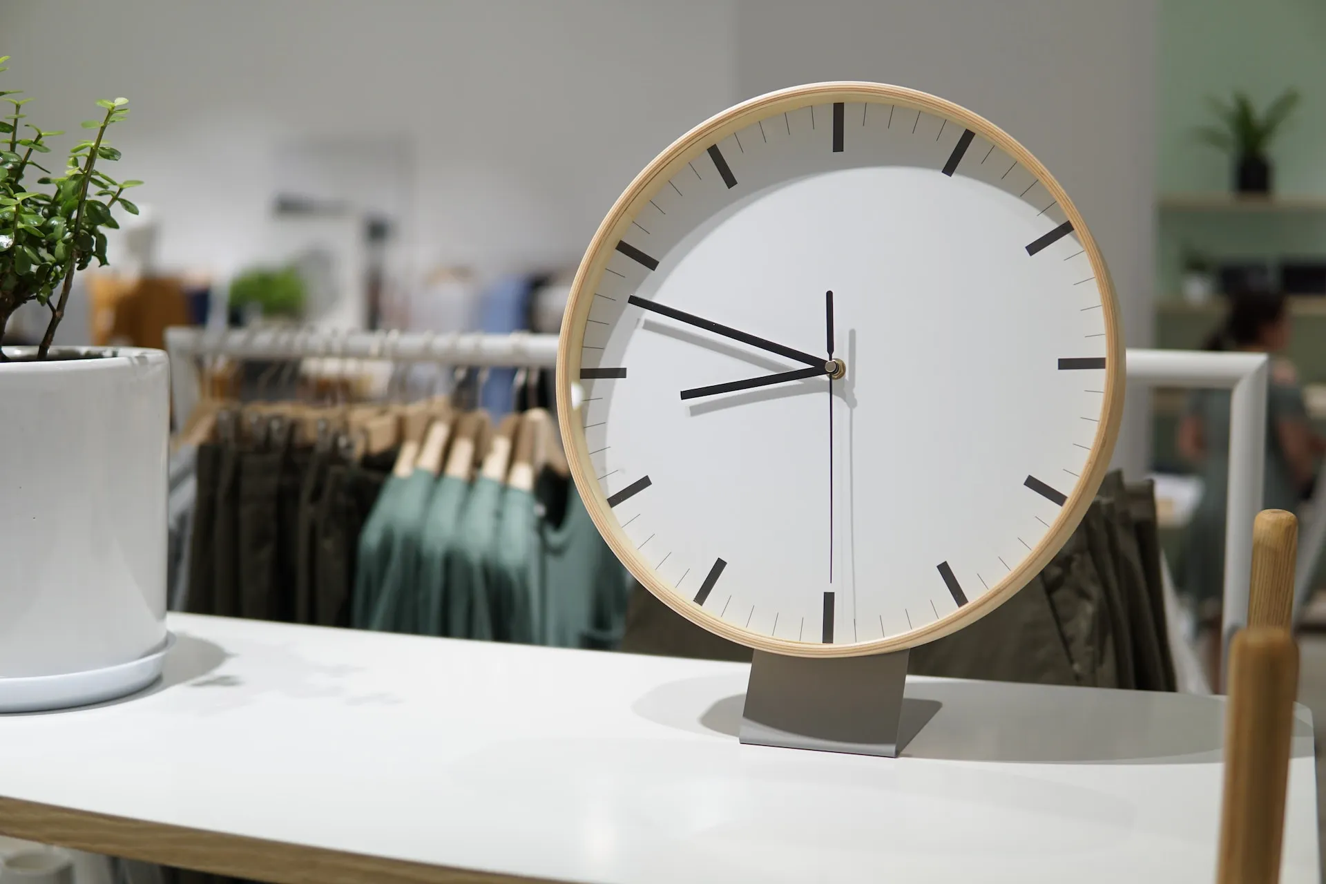 A clock on a table in a store.