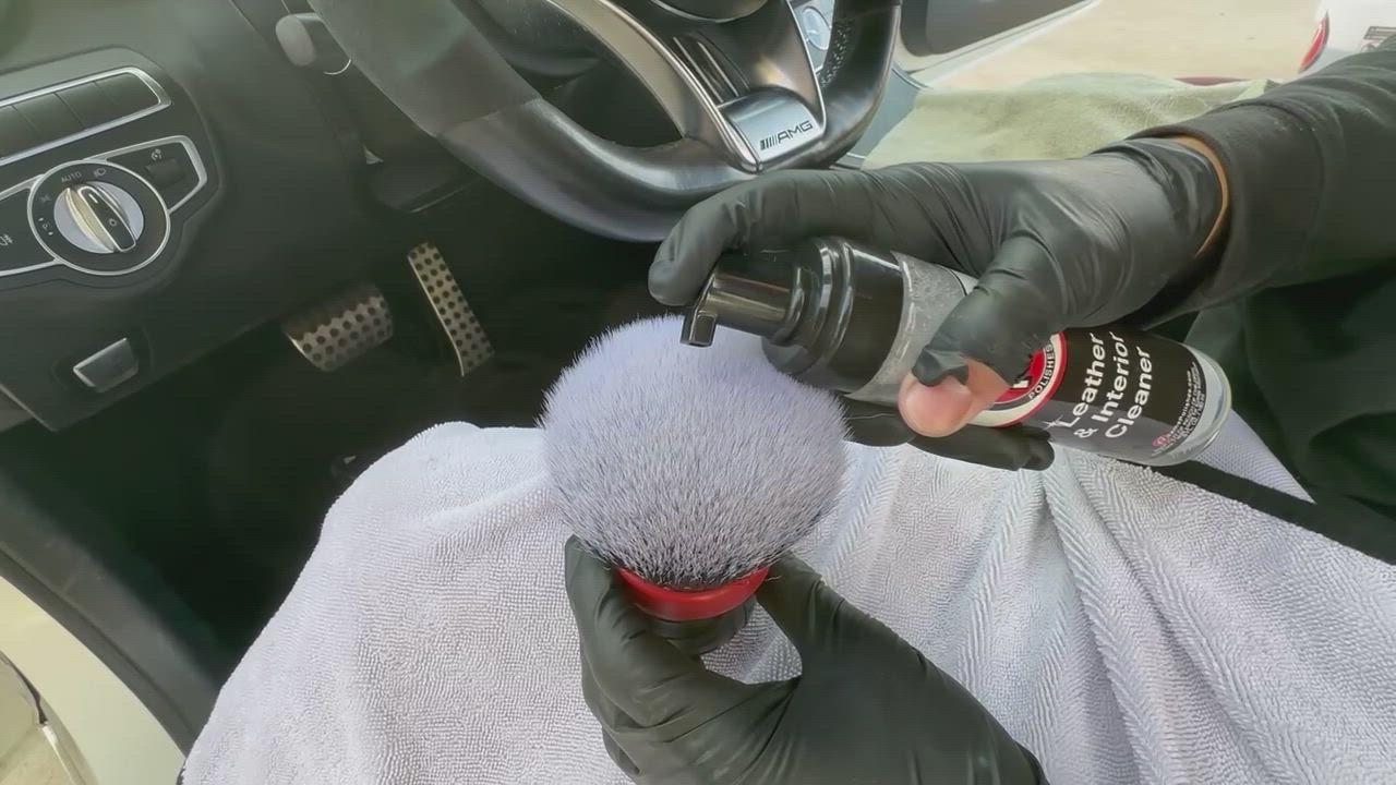 Gloved hand detailing an interior surface