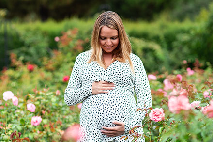 A pregnant mother cradling her pregnant belly