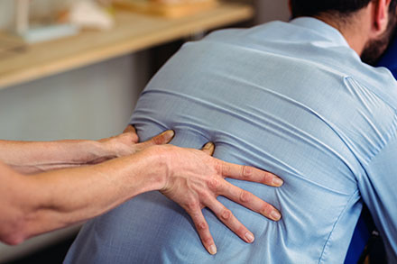 A man receiving chiropractic care
