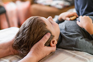 A child laying on their having chiropractic treatment