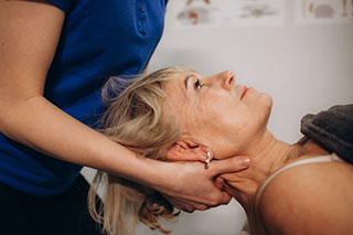 A woman laying on her back receiving chiropractic care