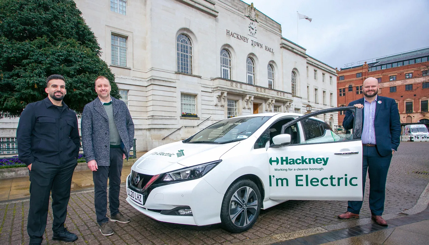 Hackney Council team outside Hackney Town Hall with electric vehicle