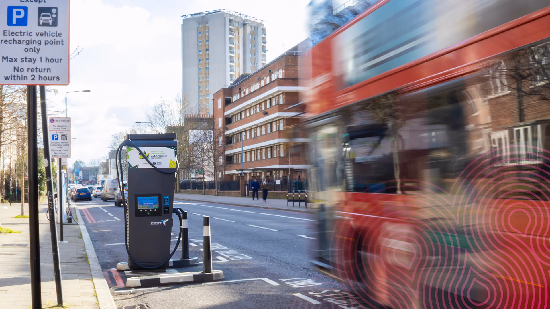 Red bus passing Zest charger on London red route