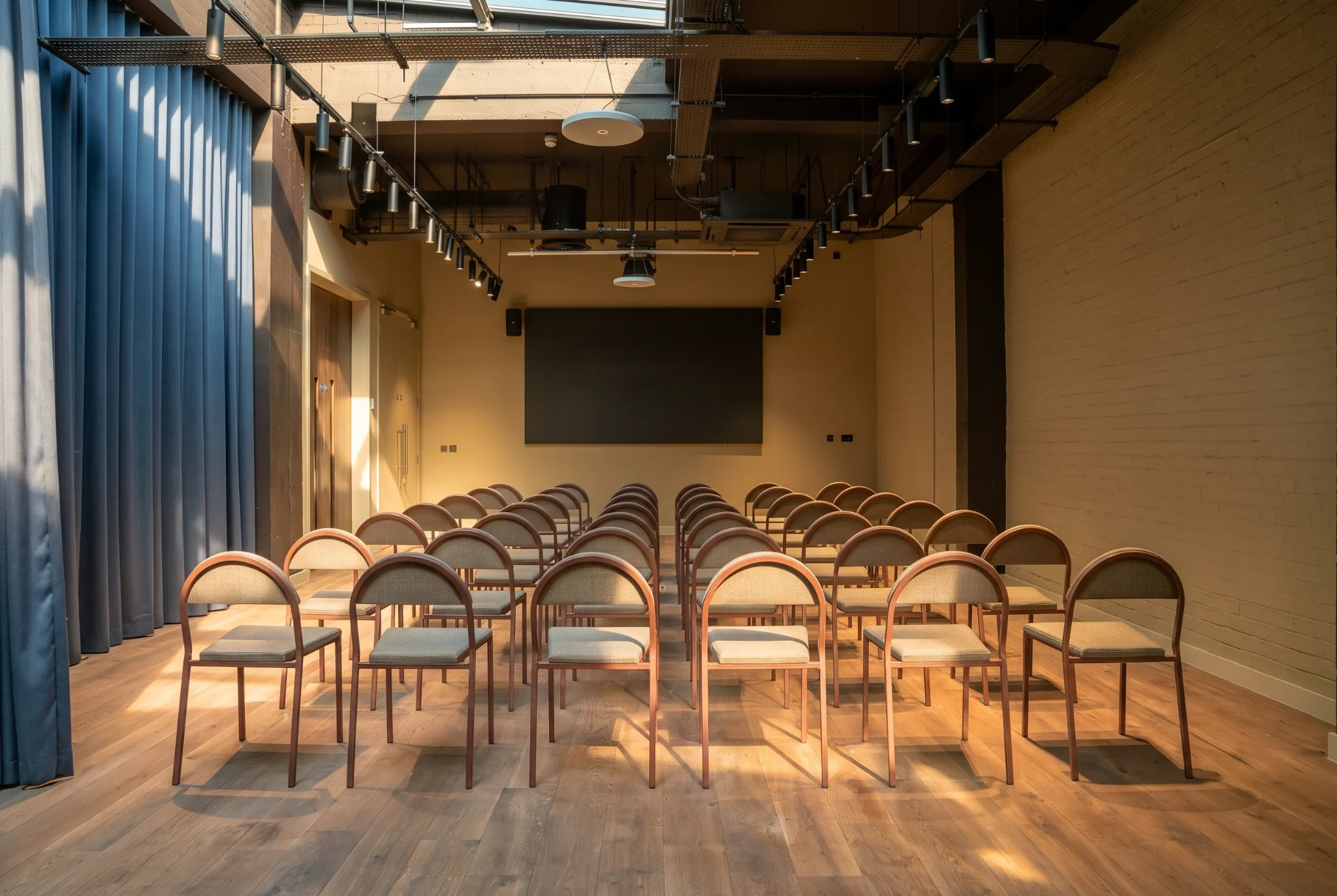 The Stage at Qube Shoreditch with curtains and seating set up for an event