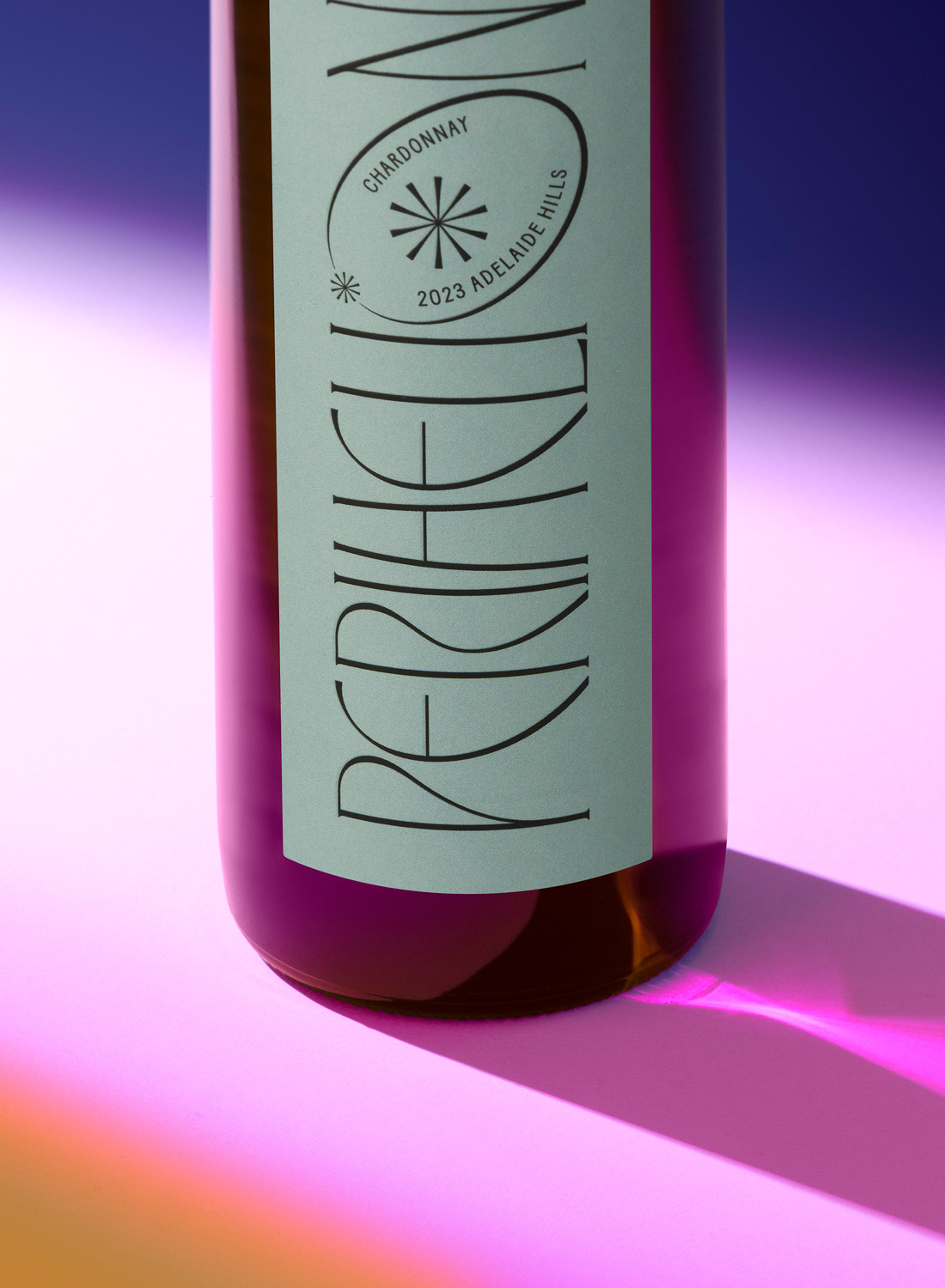 Stylized wine bottle with bold label on gradient purple background.