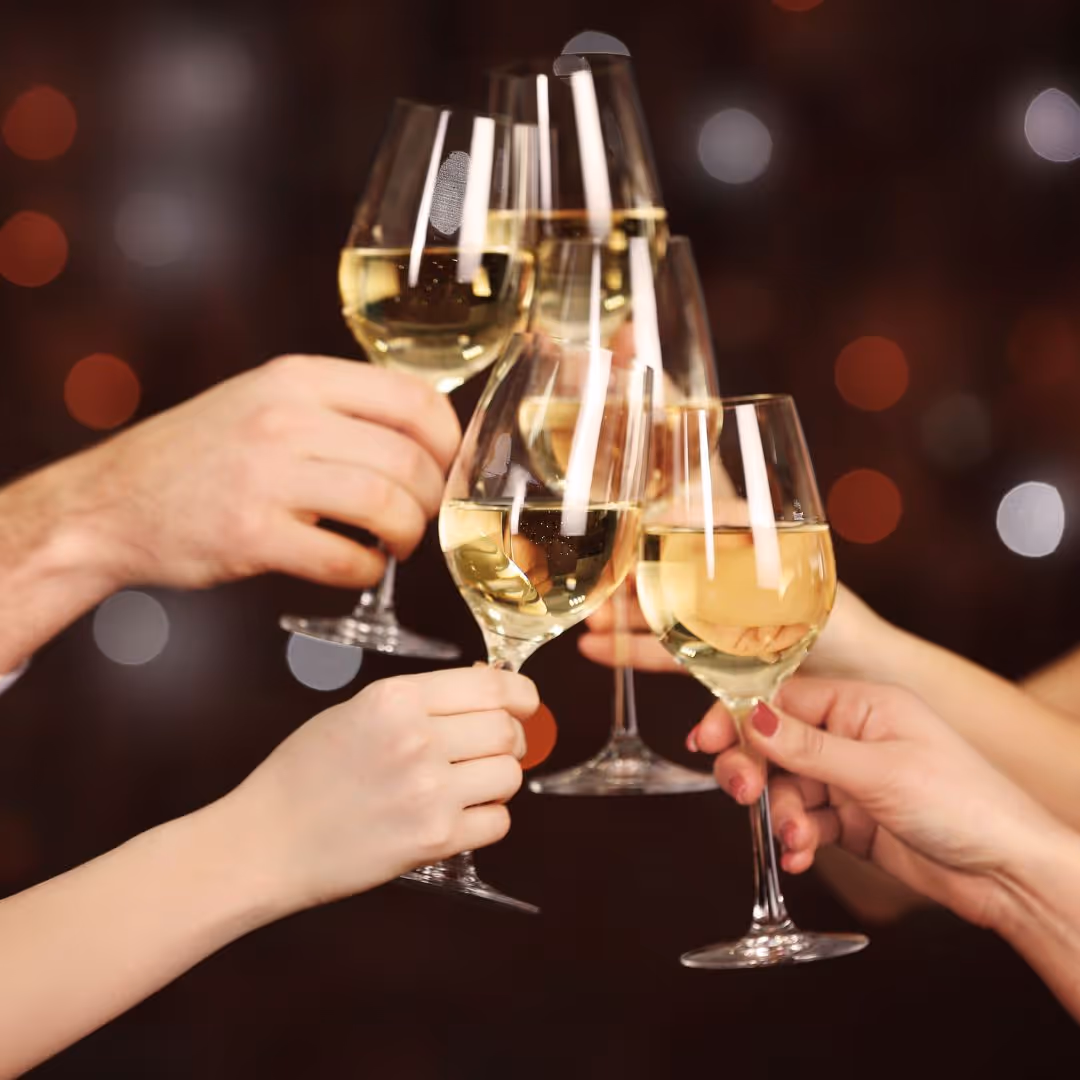 A group of people toasting with wine glasses.