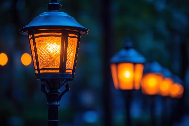 A street light with a lot of lights in the background.