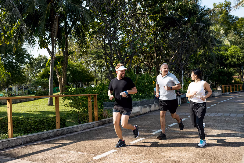 A group of people running down a street.