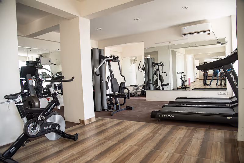 A gym with treadmills and exercise machines.