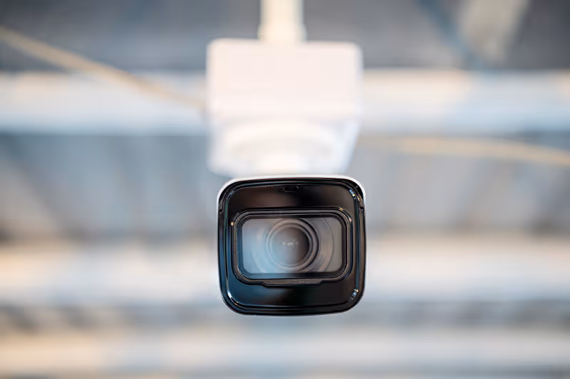 A close up of a camera attached to a ceiling.