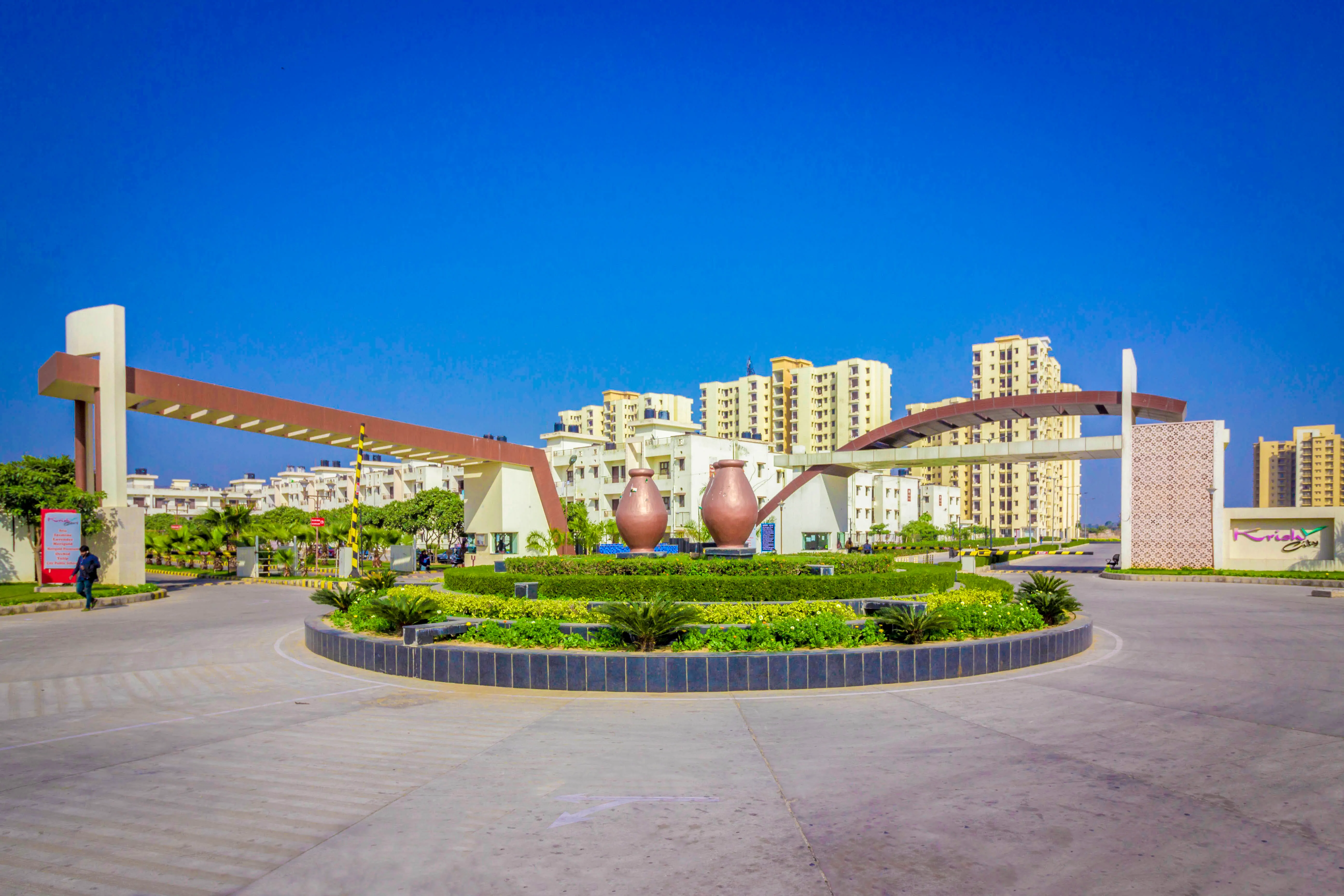 A circular garden in front of a large building.