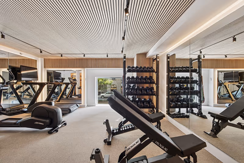 A gym with a variety of exercise equipment.
