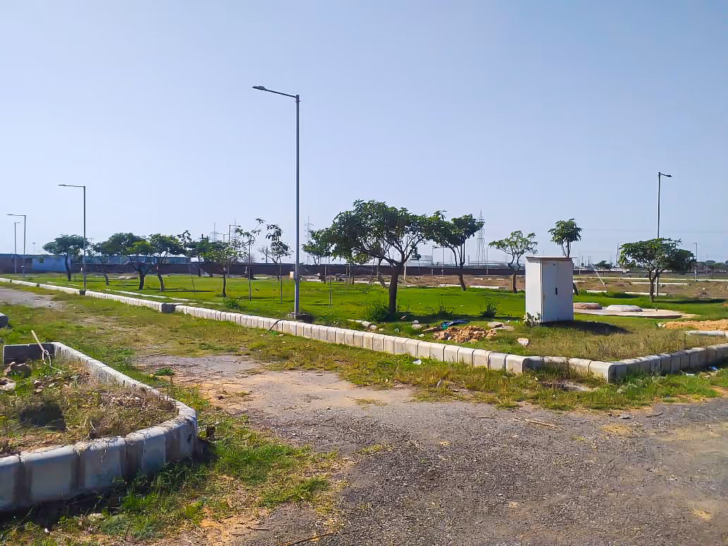 A grassy field with a small building in the middle of it.
