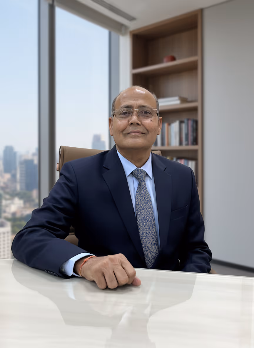 A man in a suit and tie sitting at a desk.