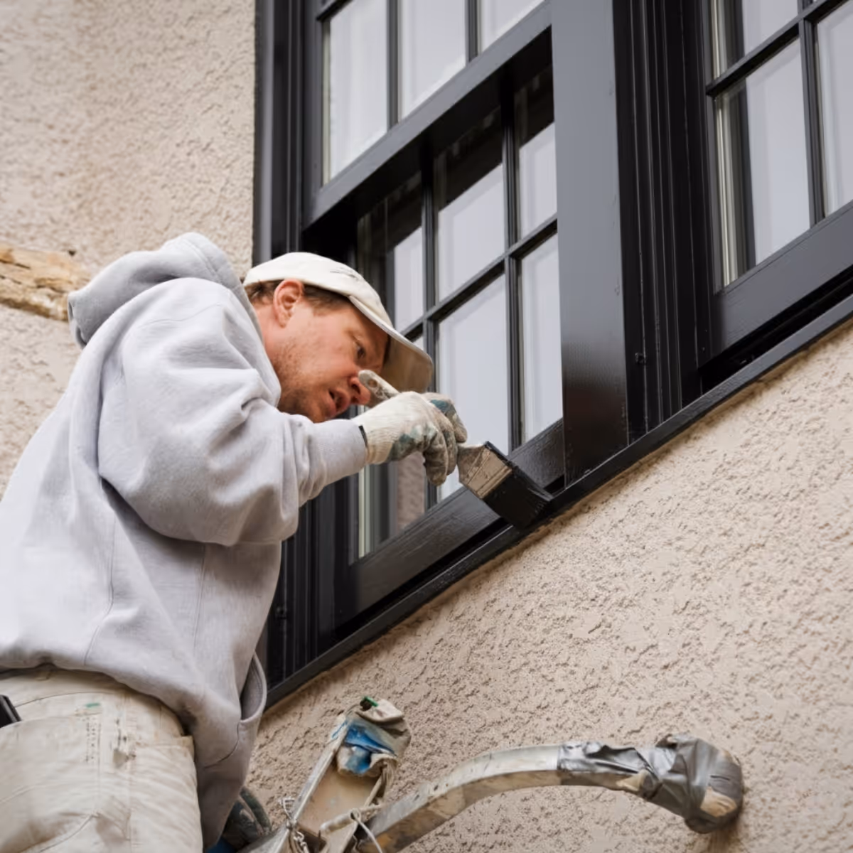 Man painting exterior window