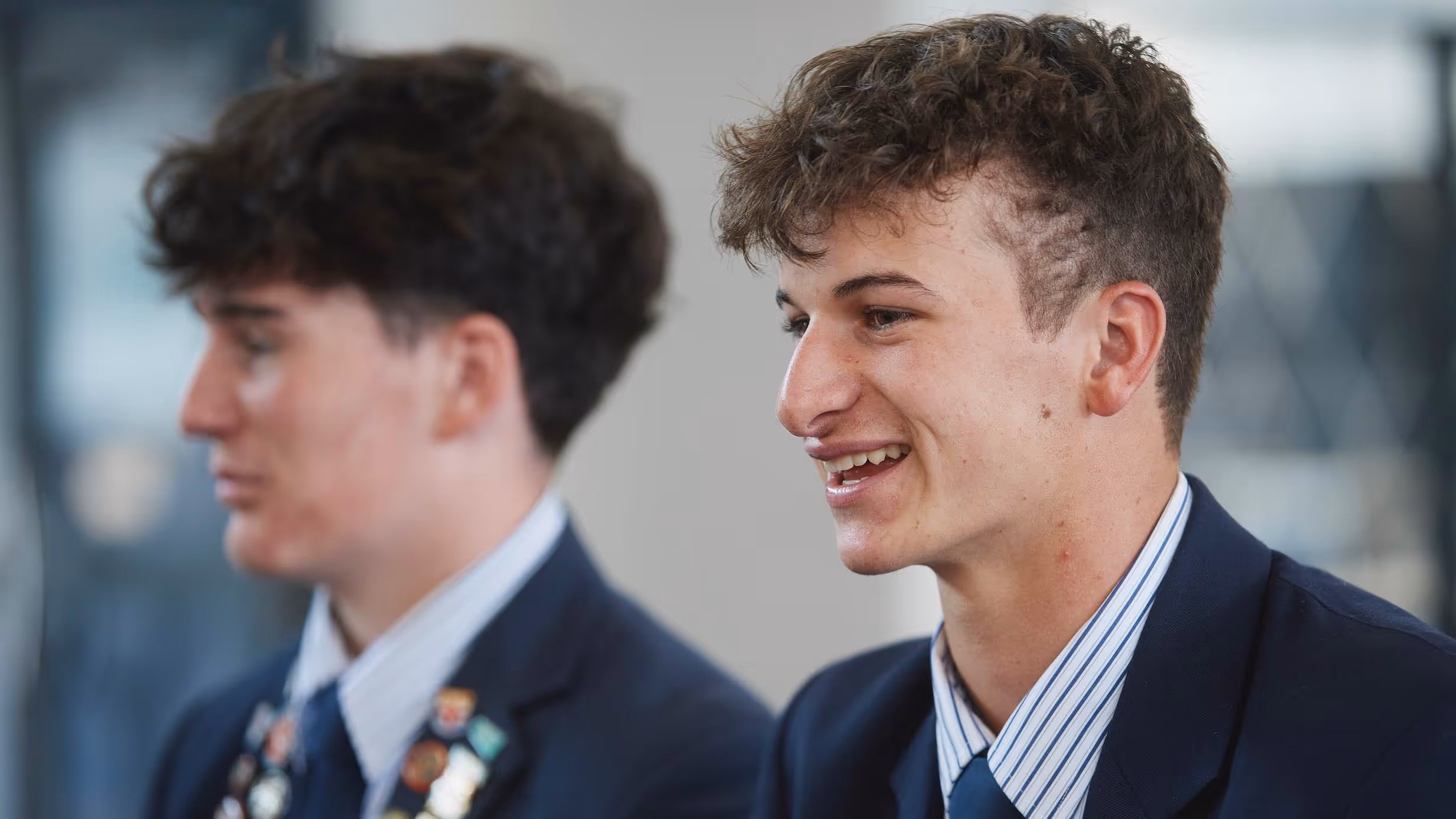 A stained glass window with the original owl and crest