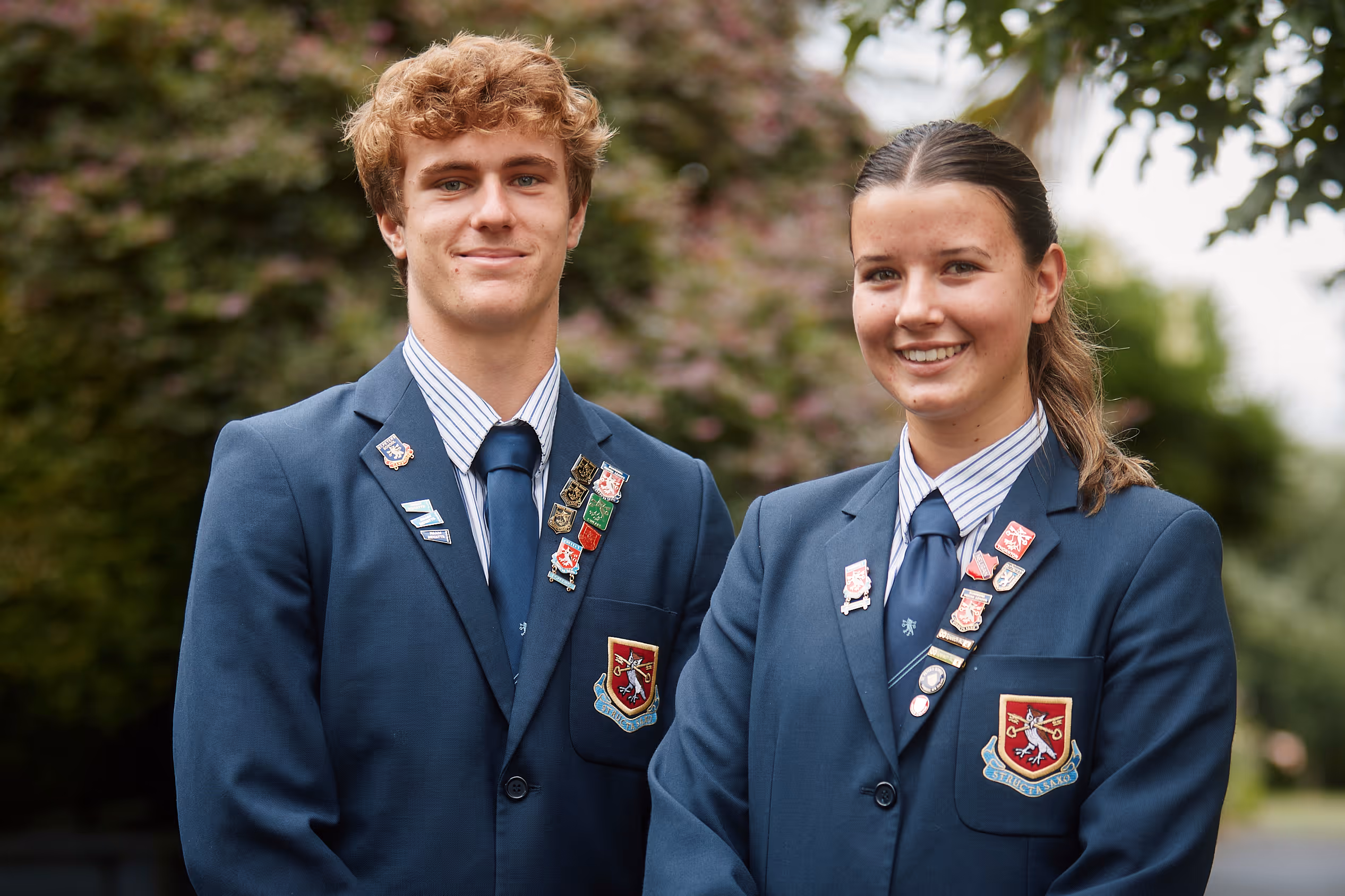 A group of four students walking on a golf course