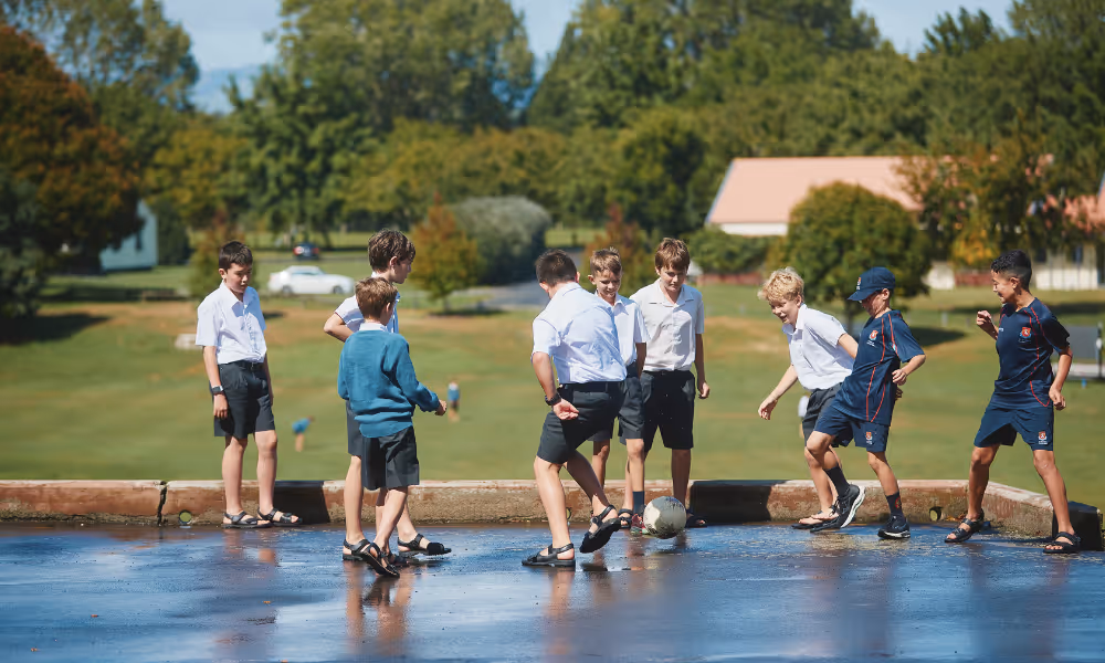 Two students riding bikes on campus