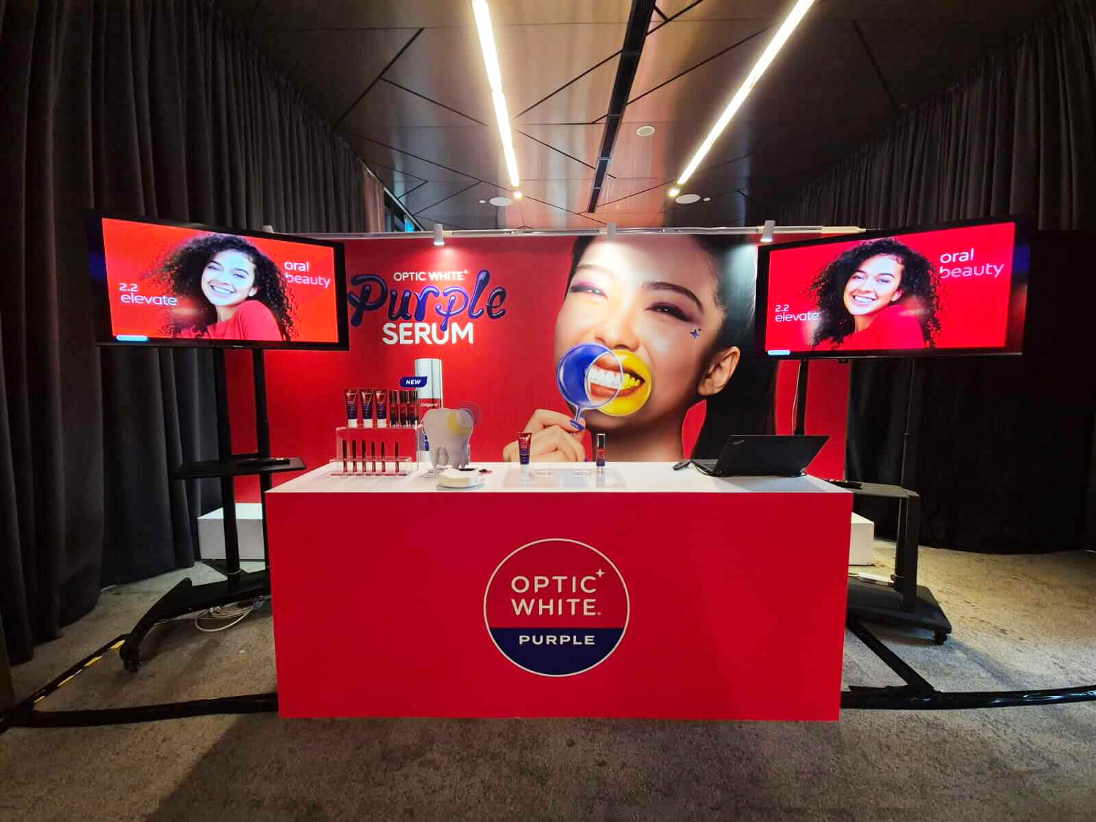 Brand Activations & Experiences_Brand Campaign Events_Colgate Elevate Event_Singapore

A promotional booth for Colgate's Optic White Purple Serum featuring bright graphics and product displays, highlighting oral beauty in a branded event setting.

