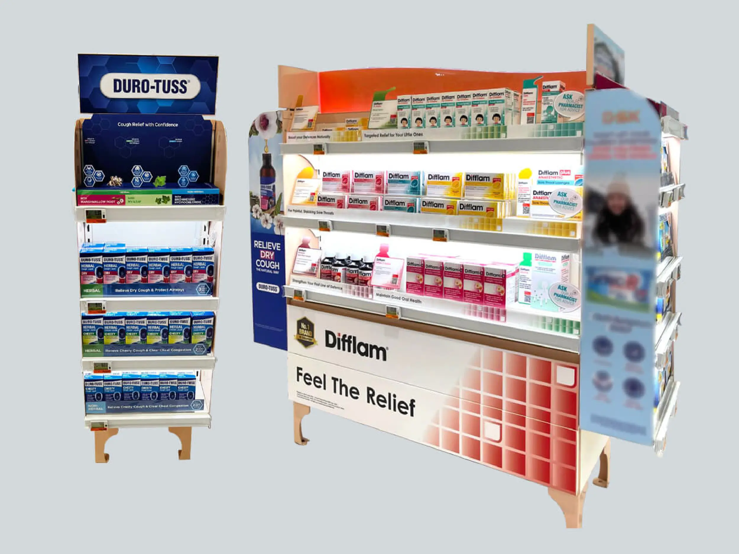 Retail display stands featuring DURO-TUSS cough relief products on the left and Diffam throat relief products on the right with signage promoting cough and throat care.