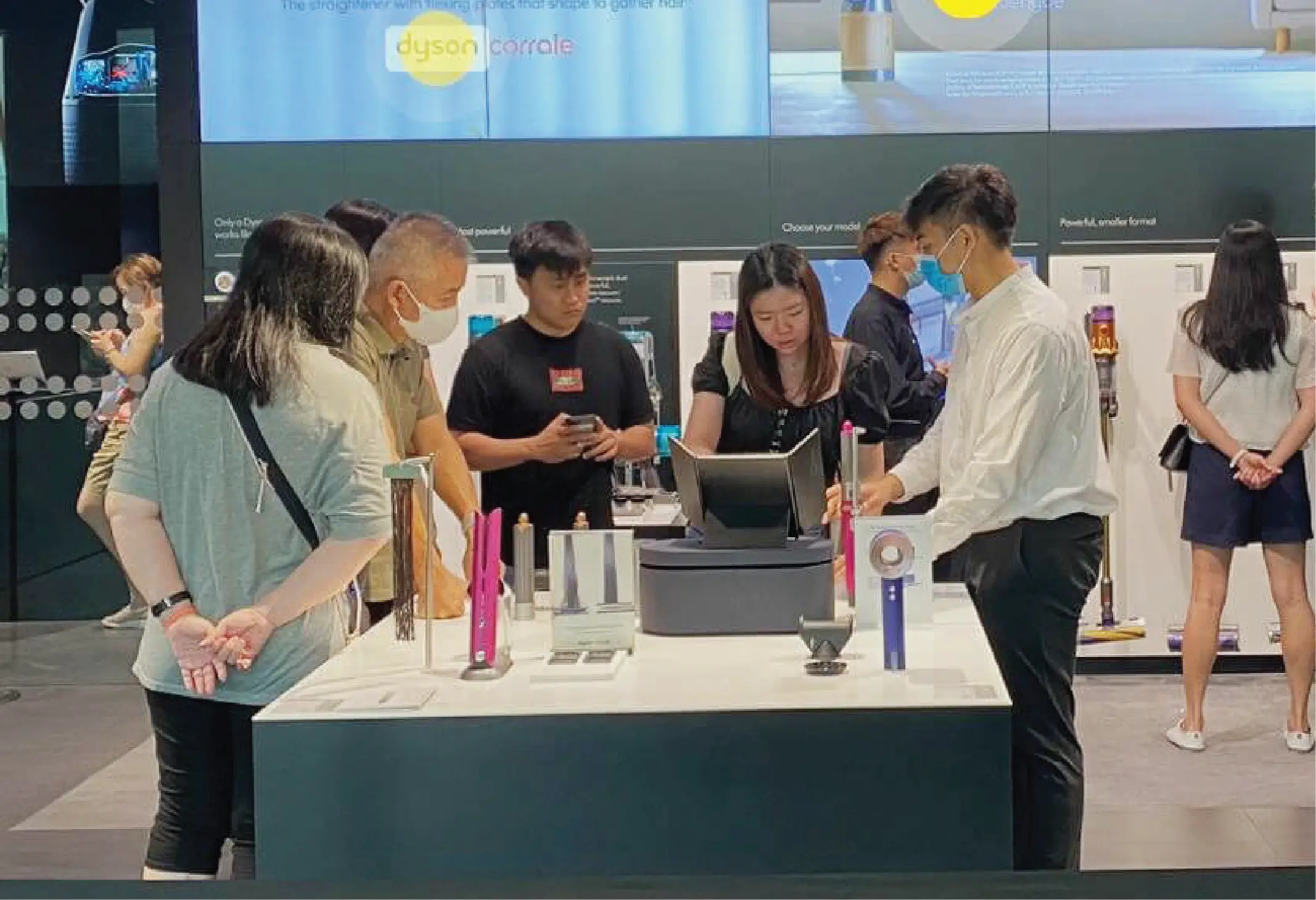 Brand Activations & Experiences_Shopper Engagements_Dyson Ambassador Singapore

A group of shoppers engages with Dyson products at a display. A brand ambassador assists customers at a counter, while various Dyson appliances are showcased in the background.