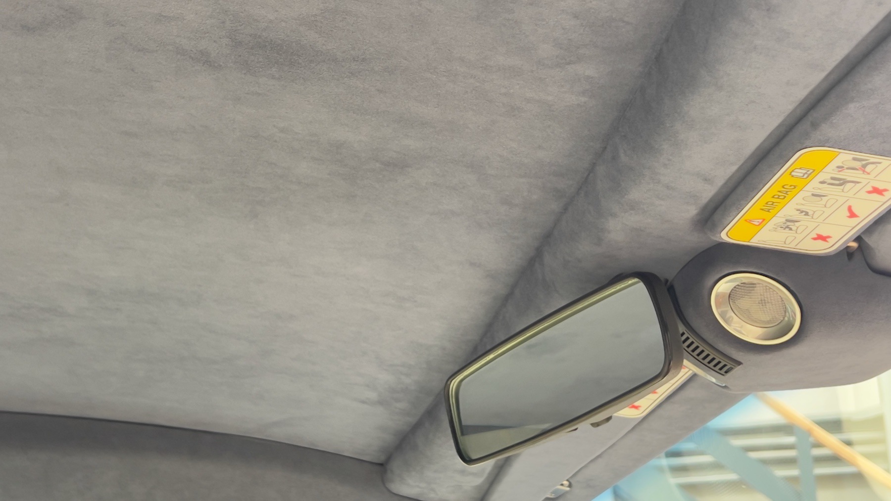 Blue suede headlining and rear-view mirror in the Aston Martin DB9