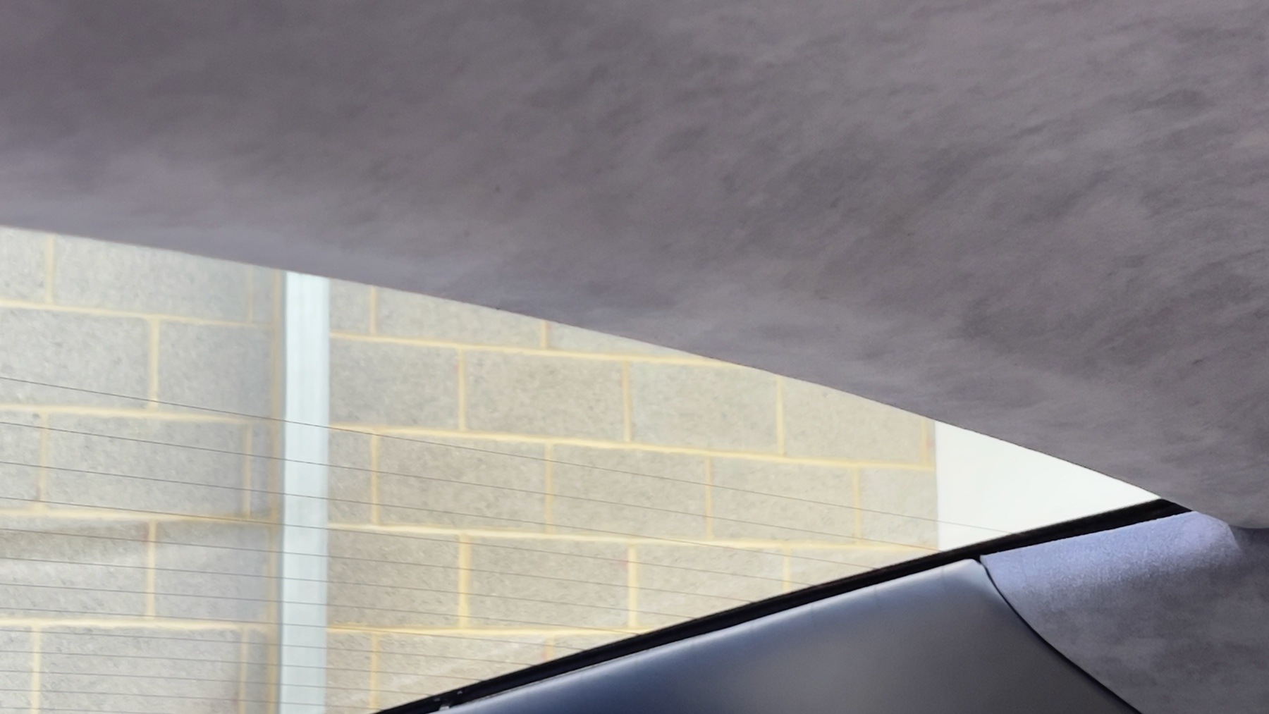 Blue suede headlining above the windscreen of the Aston Martin DB9