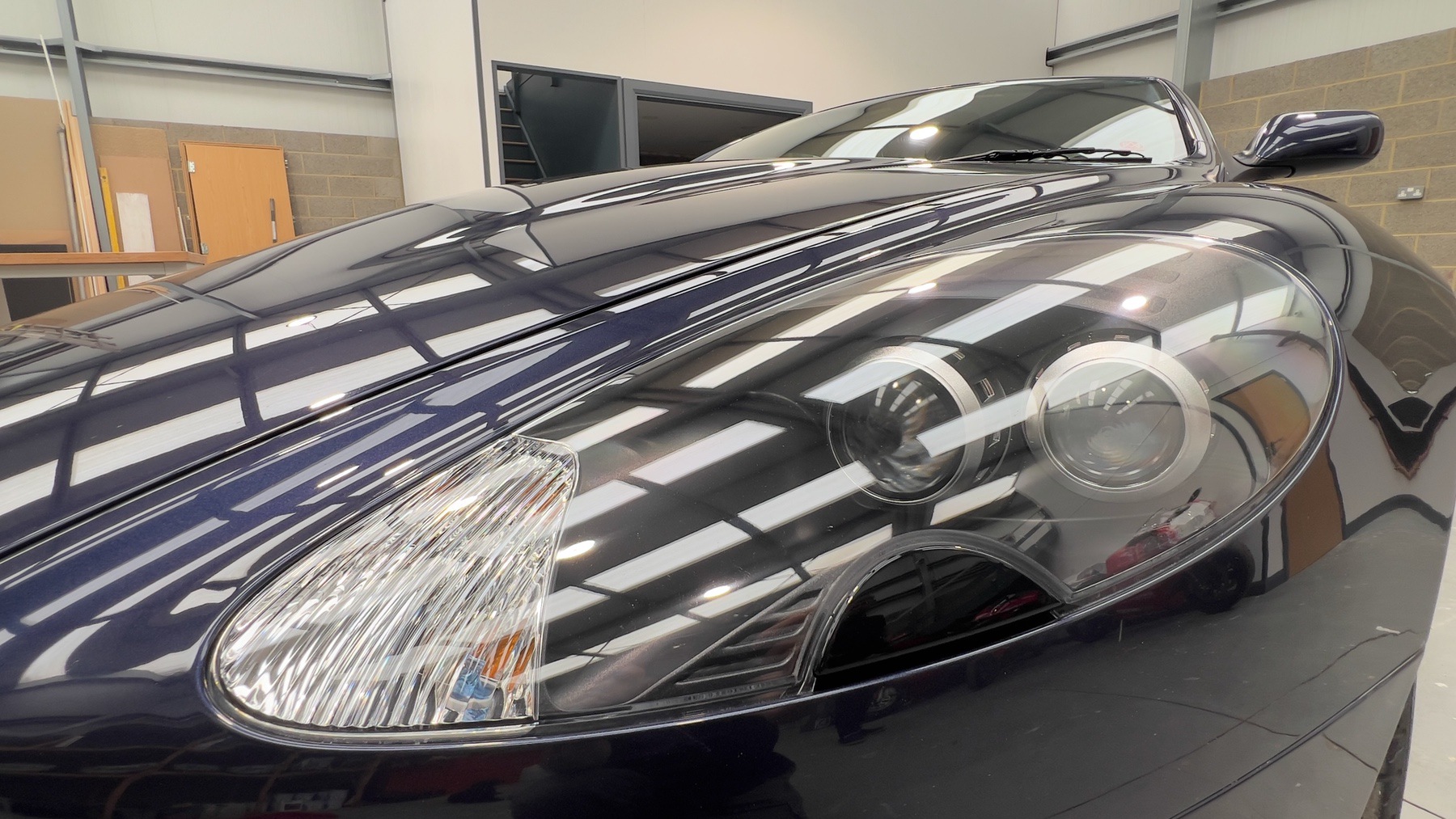 Close-up of the Aston Martin DB9's headlight and front wing