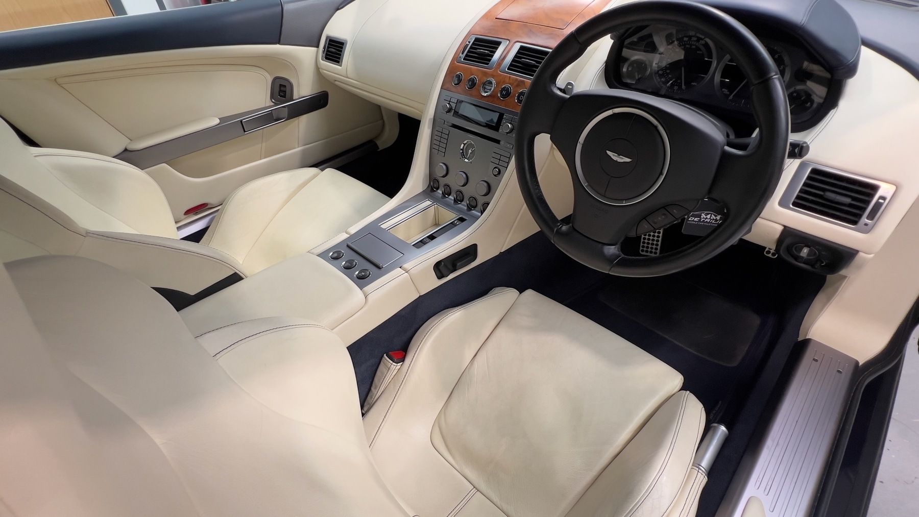 Aston Martin DB9 interior in parchment leather with walnut fascia and centre console