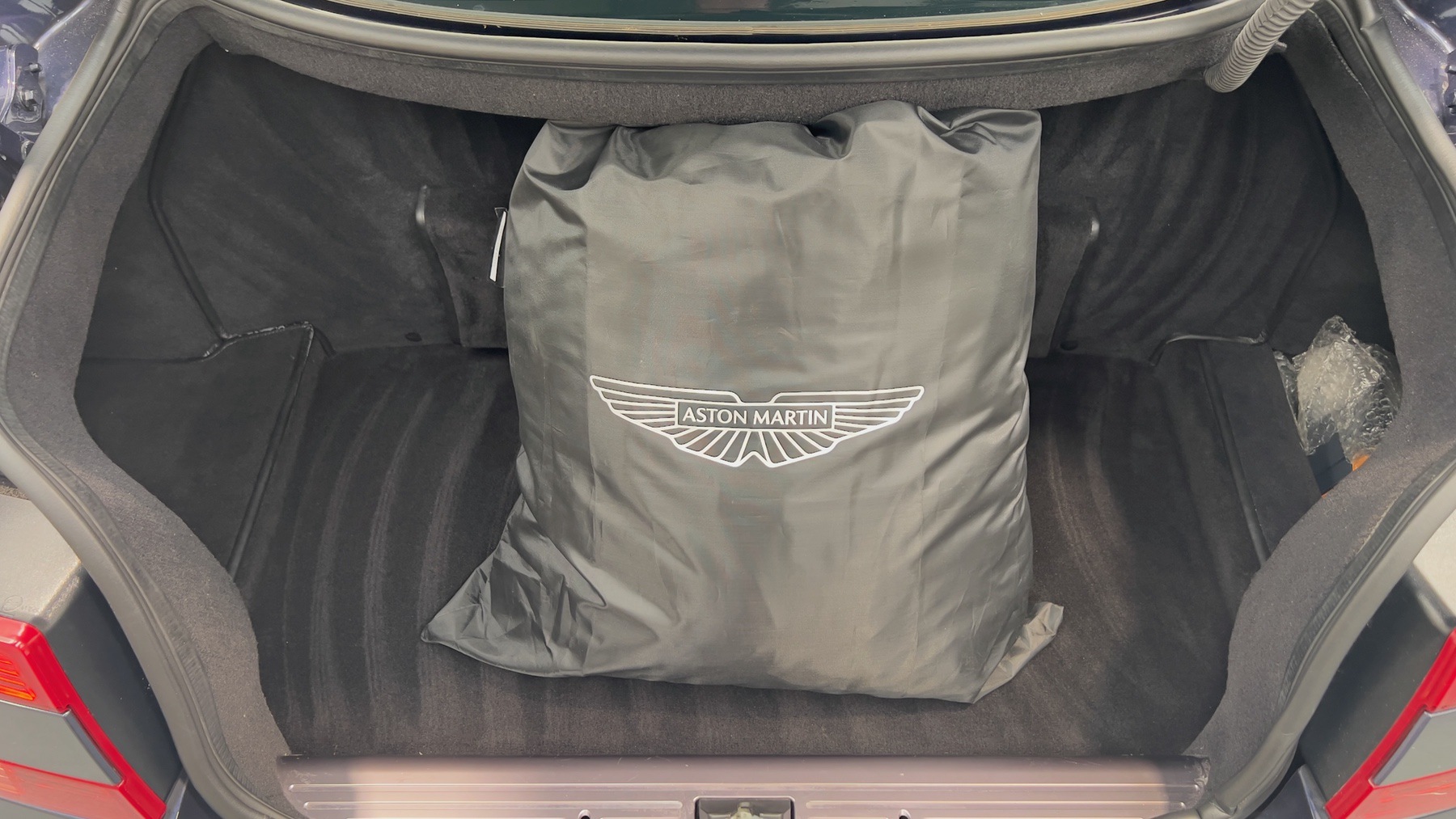 Aston Martin DB9 boot containing the branded Aston Martin car cover bag
