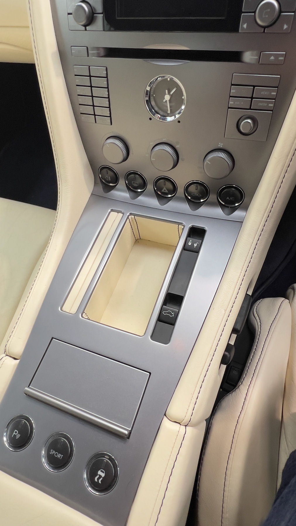 Aston Martin DB9 centre console with analogue clock, audio and climate controls