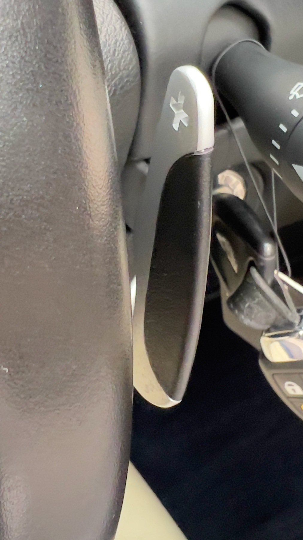 Aluminium gearshift paddle behind the Aston Martin DB9's steering wheel
