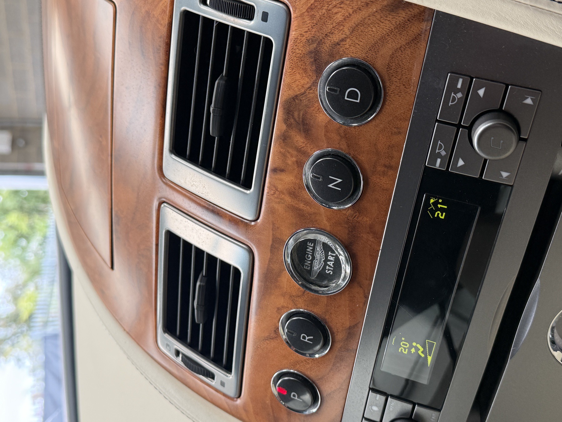 Walnut centre stack of the Aston Martin DB9 with Engine Start button and D, N and R gear selectors