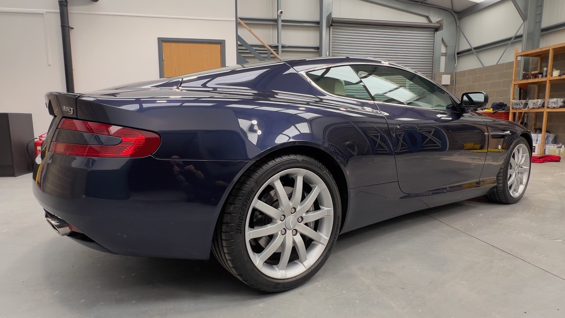 Rear three-quarter view of the Blue Sapphire Metallic Aston Martin DB9