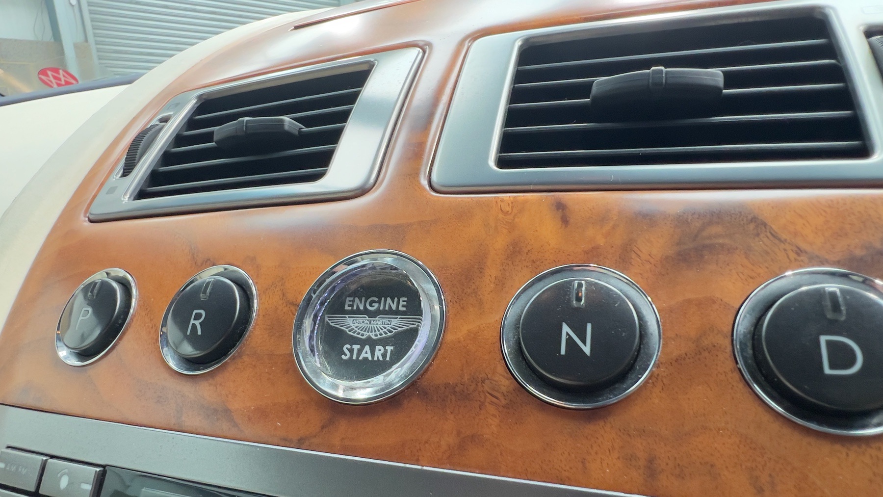Aston Martin 'Engine Start' button set into the DB9's walnut fascia