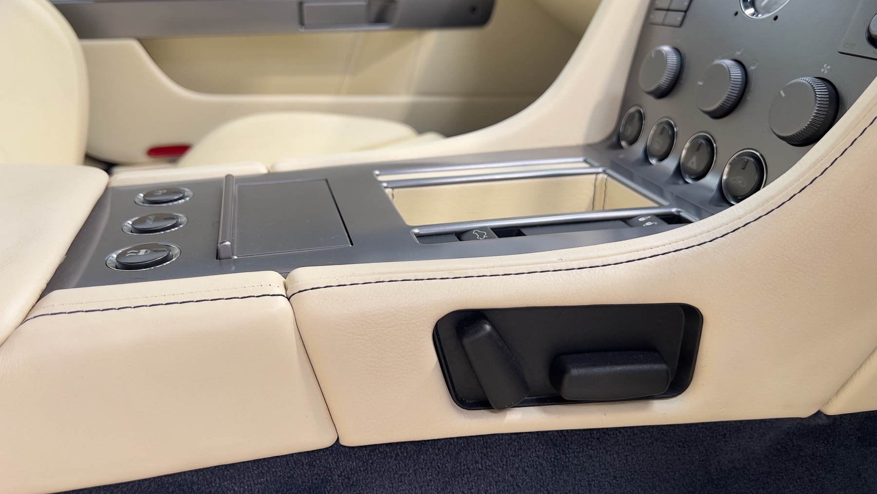 Centre console and seat controls in the Aston Martin DB9's parchment leather cabin