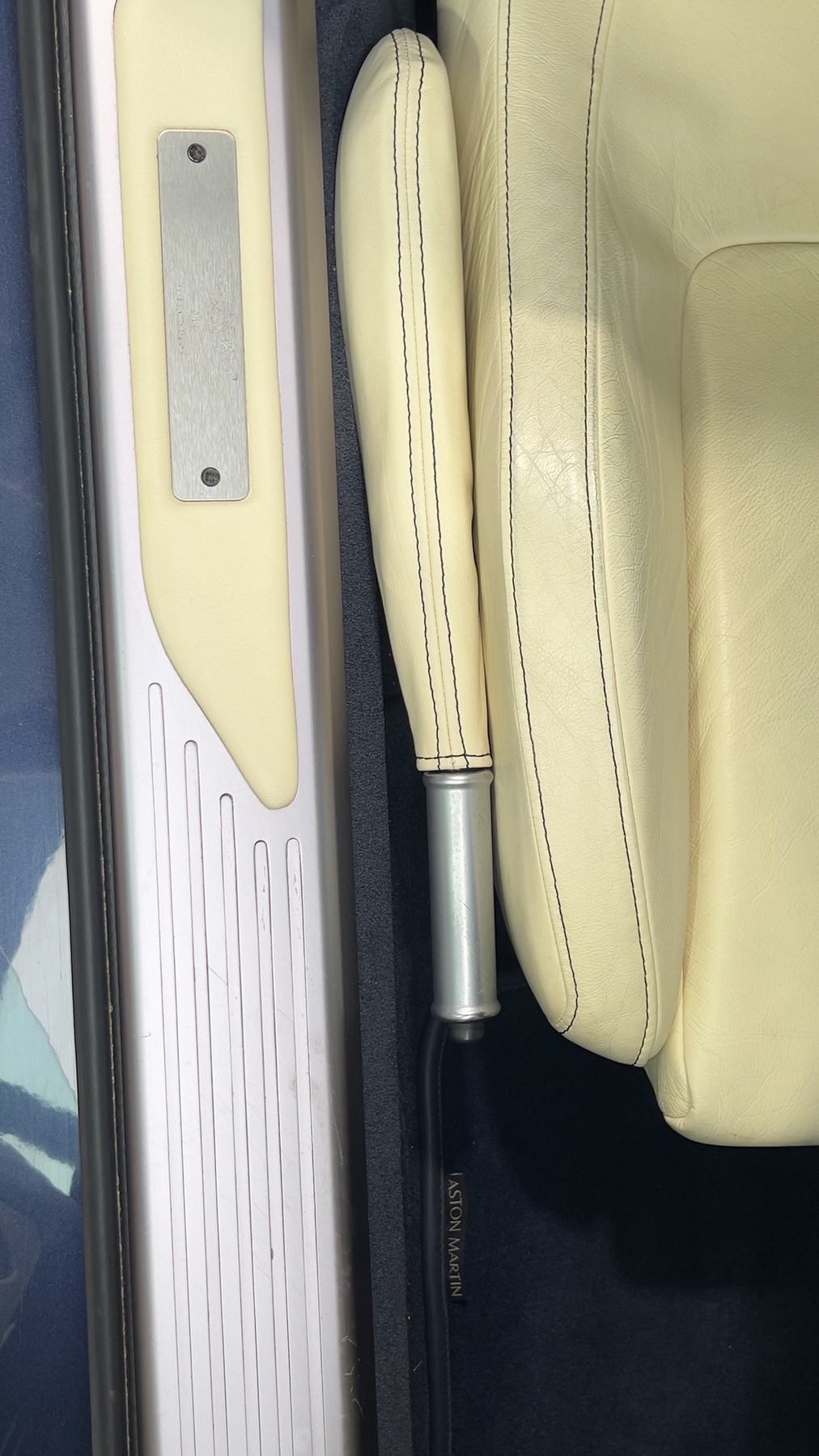 Aston Martin DB9 door sill, leather-trimmed handbrake and parchment seat