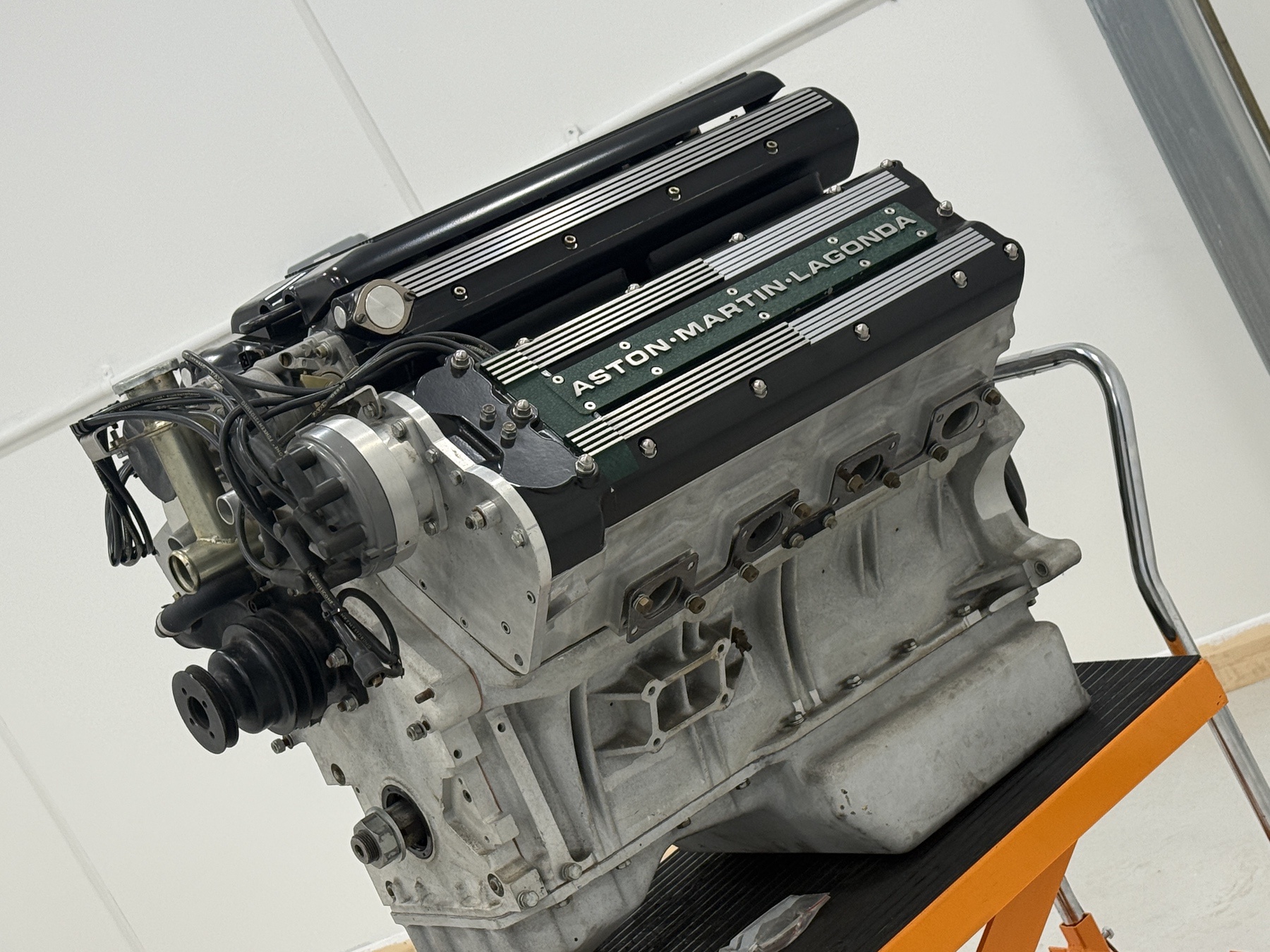 Aston Martin 7.3 litre multi-valve V8 engine on its stand, showing the alloy block and Aston Martin Lagonda cam covers