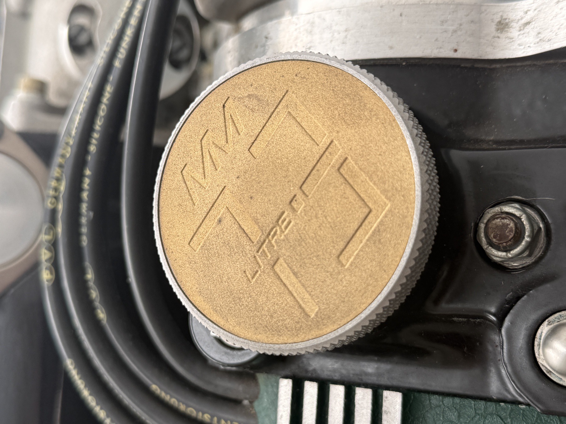 Oil filler cap engraved 'MV 7.3 Litre' on the Aston Martin multi-valve V8 engine