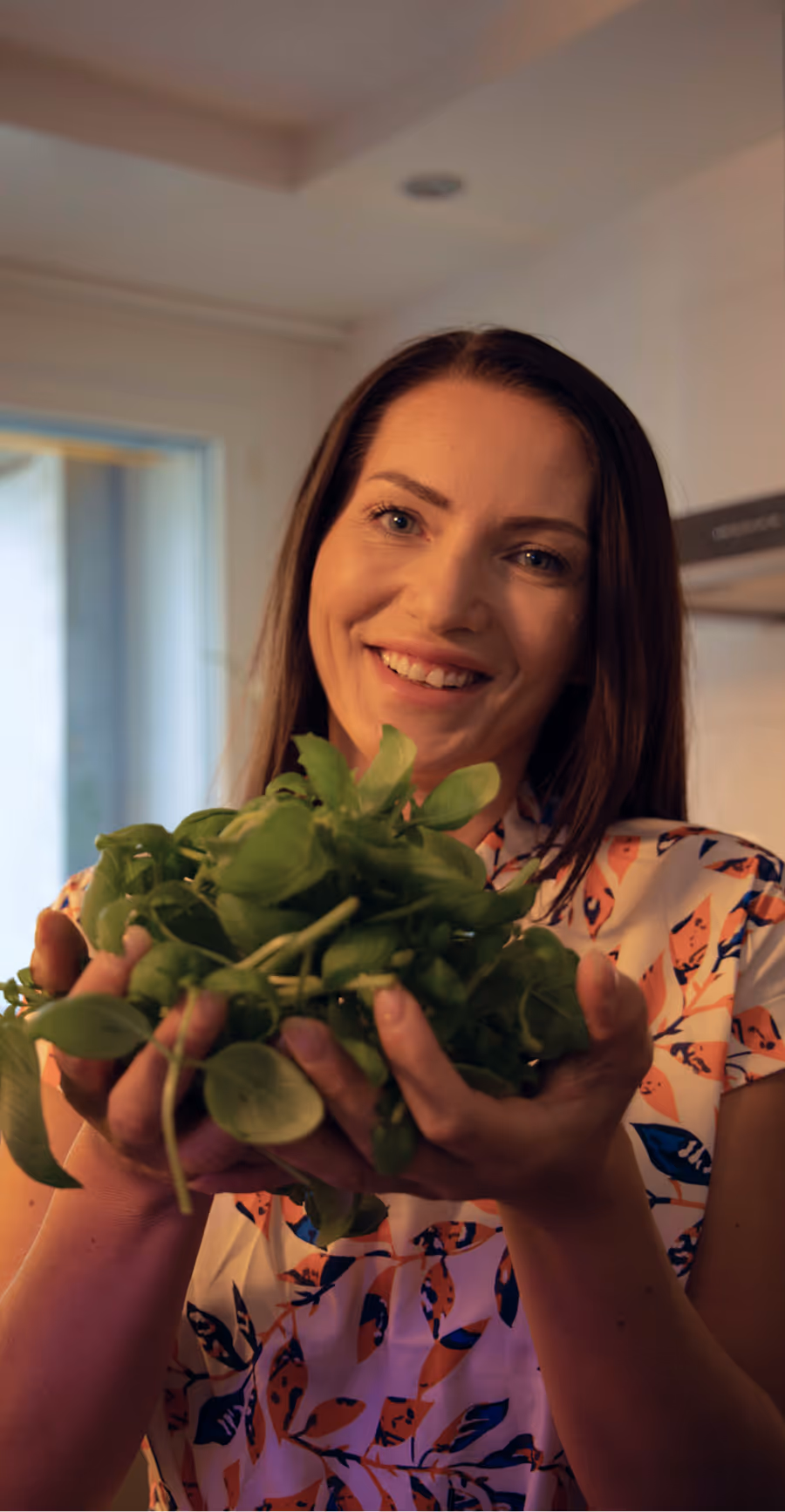 Woman holding leaves of basil