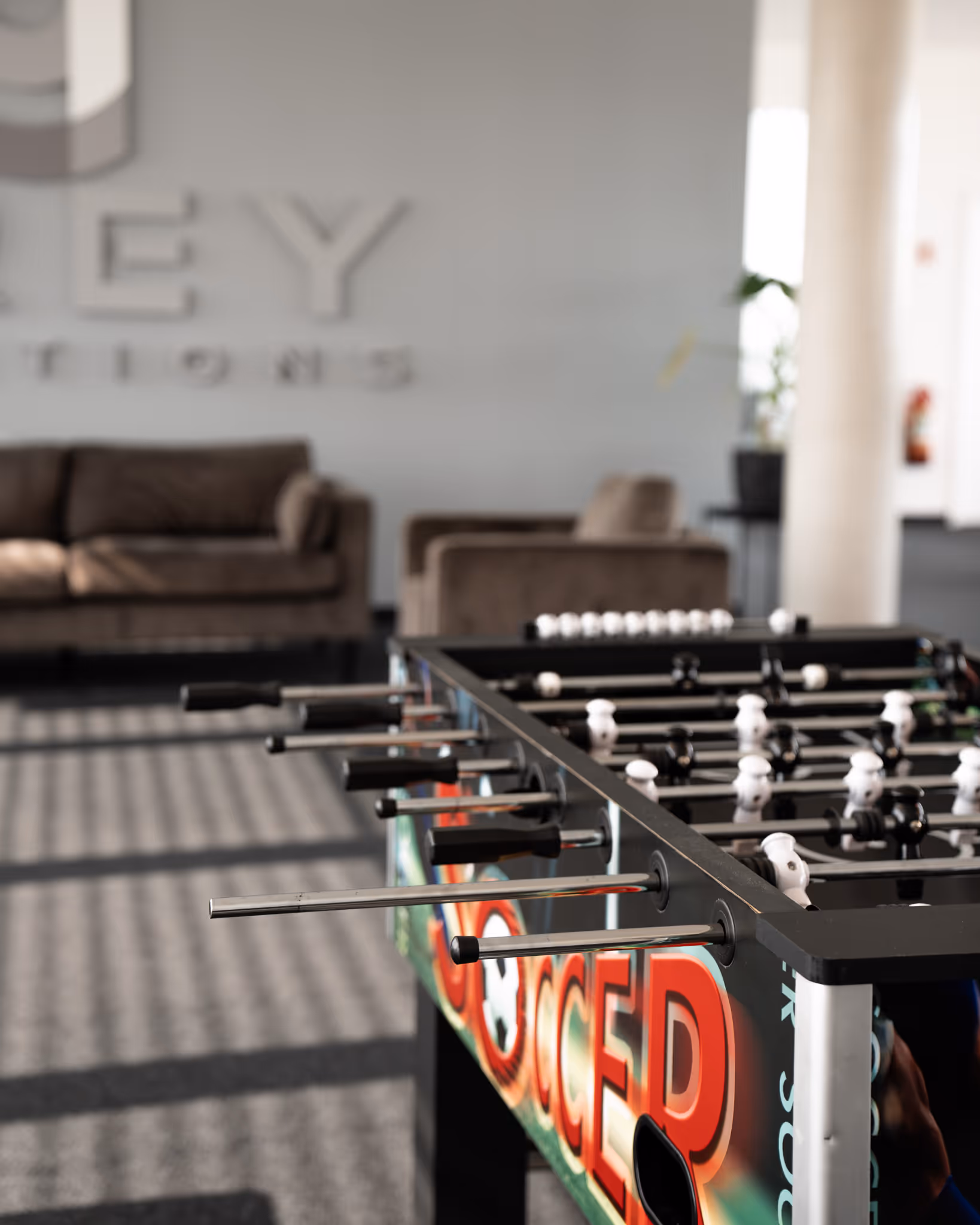 A foosball table with the words "GREY SOLUTIONS" written on the front.