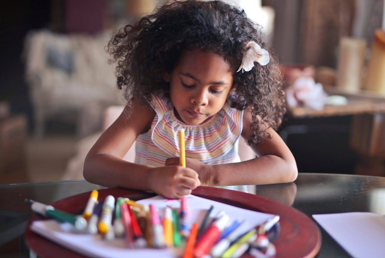 Une jeune fille métisse plongée dans un coloriage