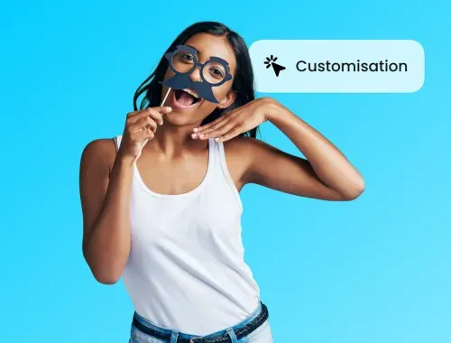 A woman holding a pair of scissors in front of her face.