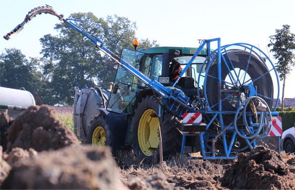 A tractor with a blue metal device on the front.