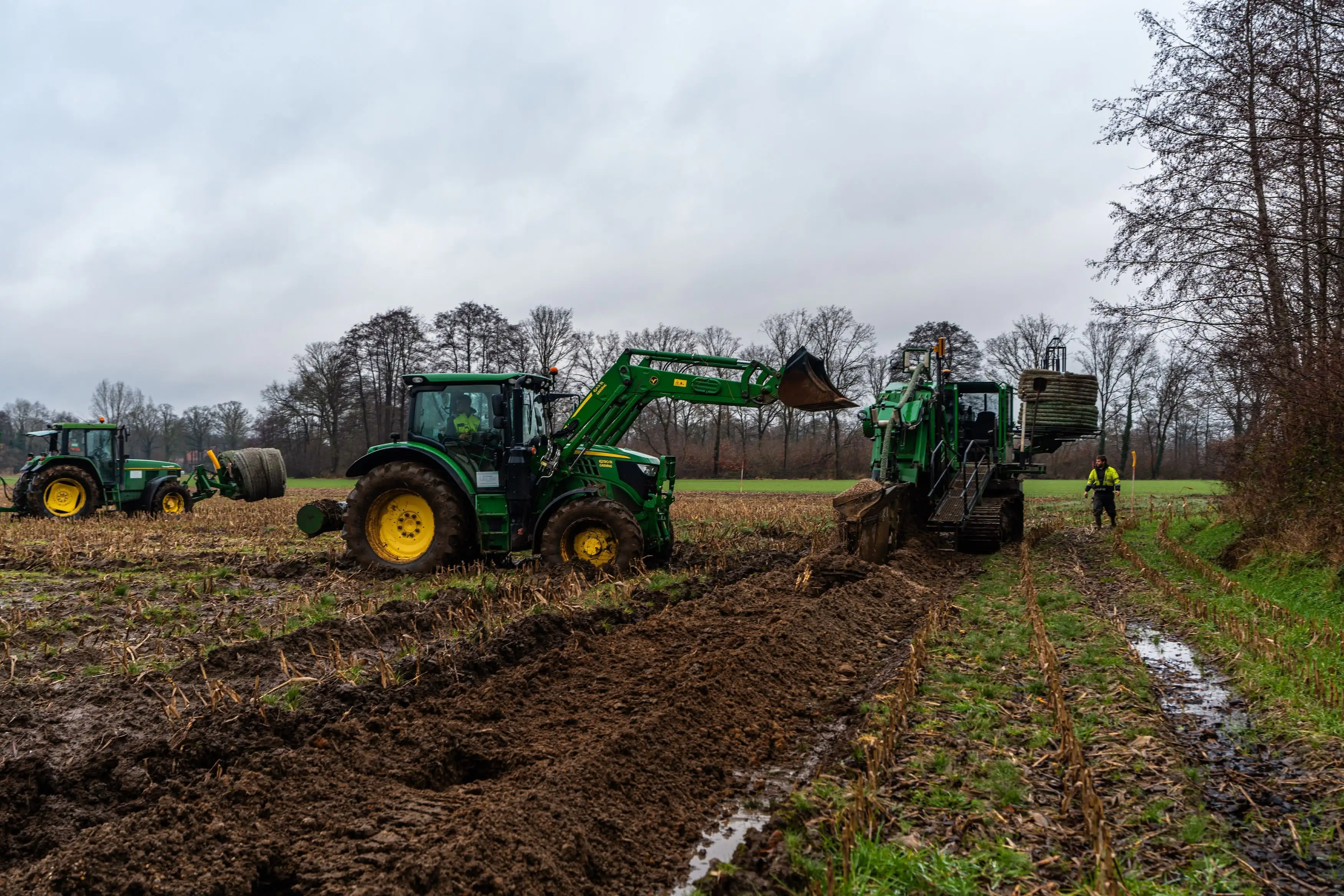 A tractor is pulling a plow in a field.