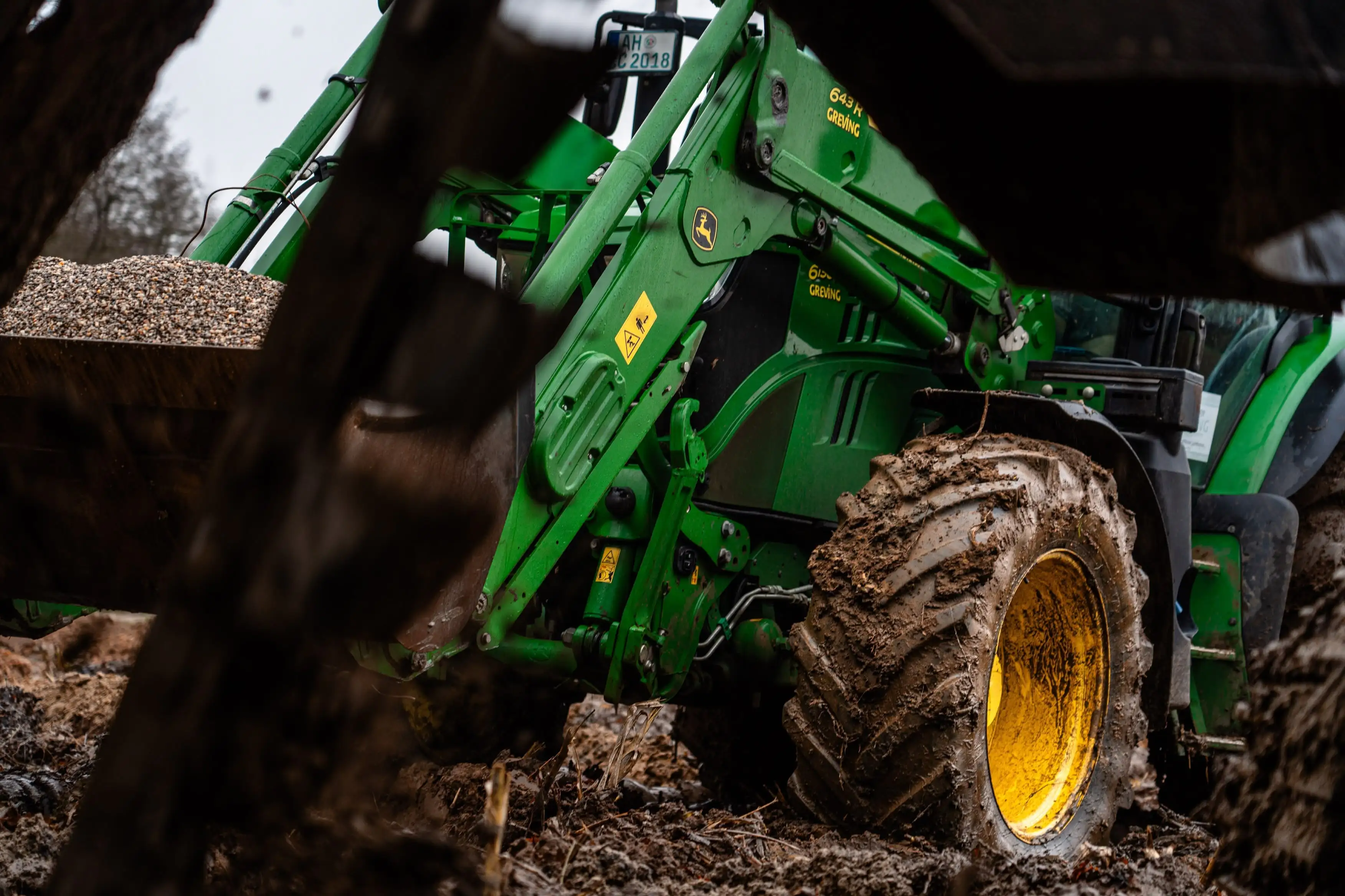 A green tractor with a yellow tire.