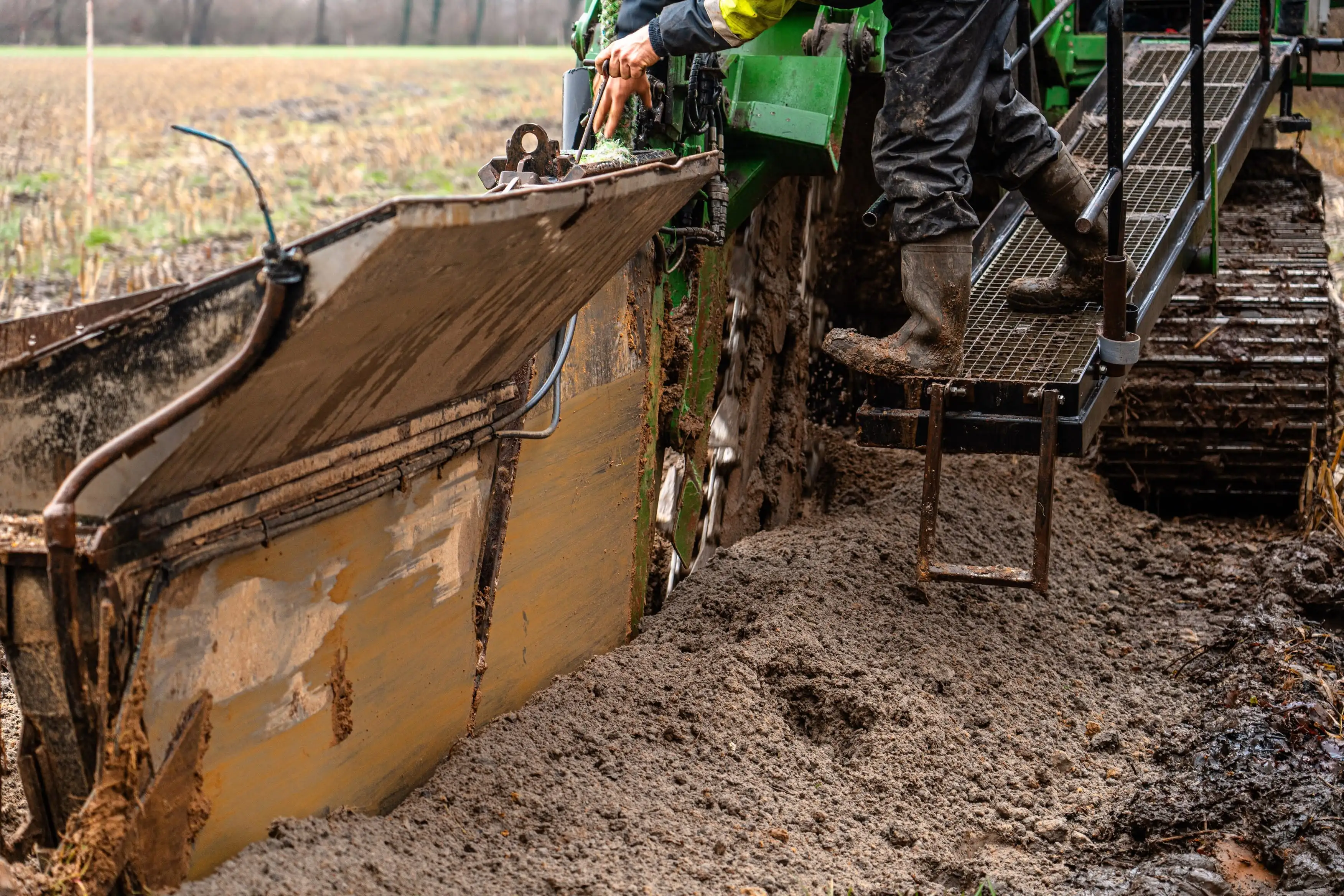 A person is standing in a pile of dirt.