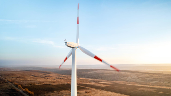 Wind turbine representing renewable energy and large-scale parts manufacturing.