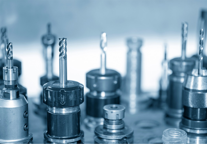 Set of worn CNC cutting tools showing invisible wear patterns and unnoticed edge engagement leading to unpredictable tool costs"